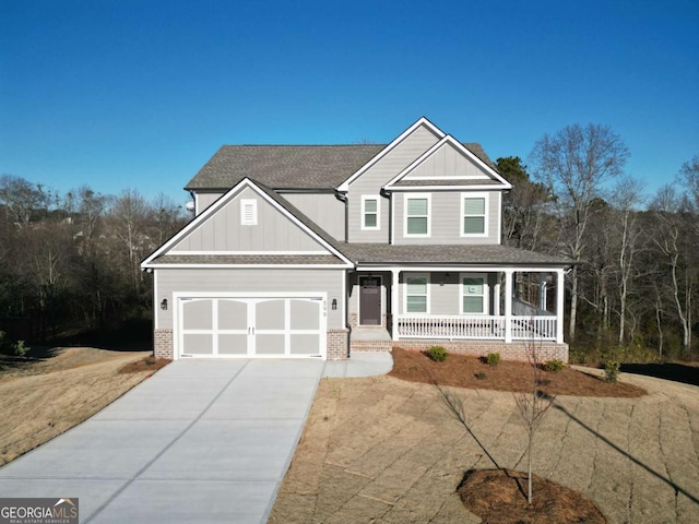 599 Calgary Downs Dr, Winder, GA 30680 - craftsman inspired home with covered porch, board and batten siding, concrete driveway, brick siding, and roof with shingles