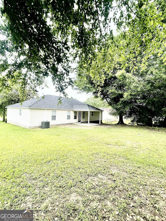 305 Lancelot Ln, Dublin, GA 31021 - rear view of house with central AC unit, a yard, and a patio