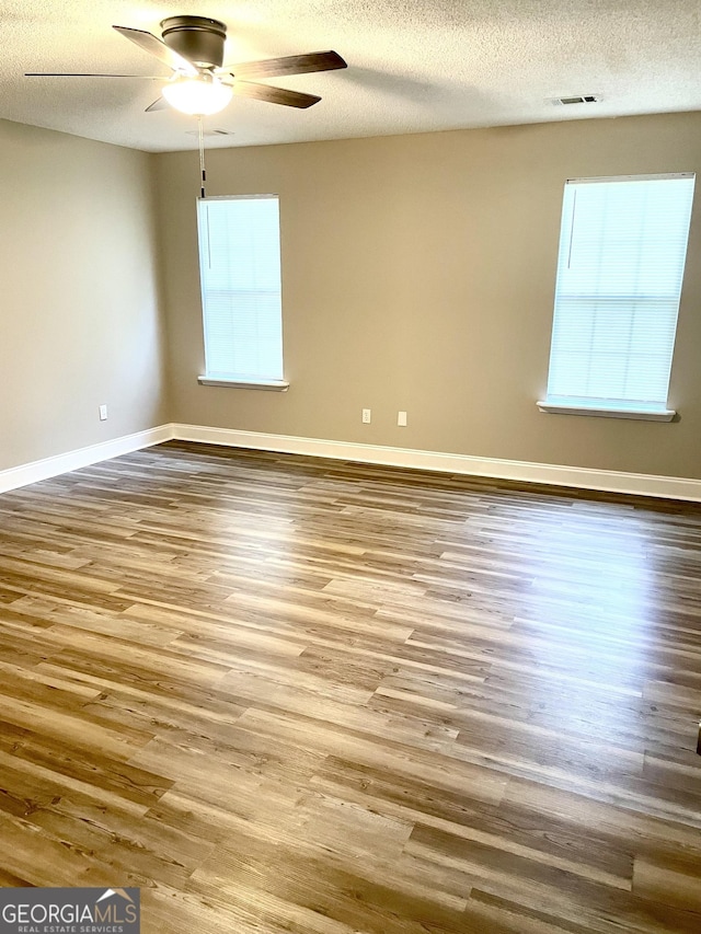 305 Lancelot Ln, Dublin, GA 31021 - empty room featuring wood finished floors, a ceiling fan, a textured ceiling, and baseboards