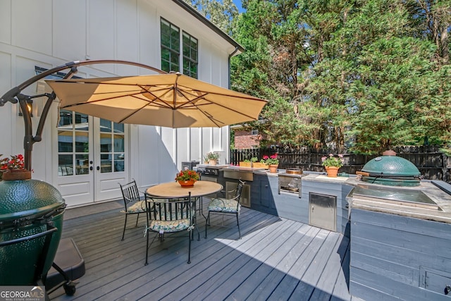 2756 Octavia Ln, Marietta, GA 30062 - wooden deck featuring an outdoor kitchen, a fenced backyard, and outdoor dining area