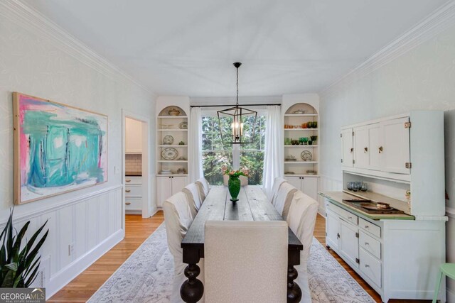 4402 Sugar Maple Pl, Gainesville, GA 30506 - dining room with a chandelier, stairway, light wood-style flooring, built in features, and arched walkways