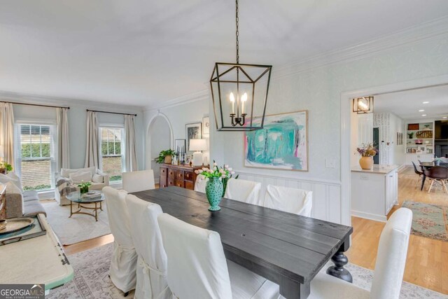 4402 Sugar Maple Pl, Gainesville, GA 30506 - dining room featuring light wood finished floors, crown molding, built in features, and a chandelier