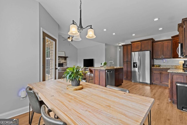 419 Highland Pointe Dr, Alto, GA 30510 - dining area with a chandelier, a fireplace, light wood-style floors, recessed lighting, and ceiling fan