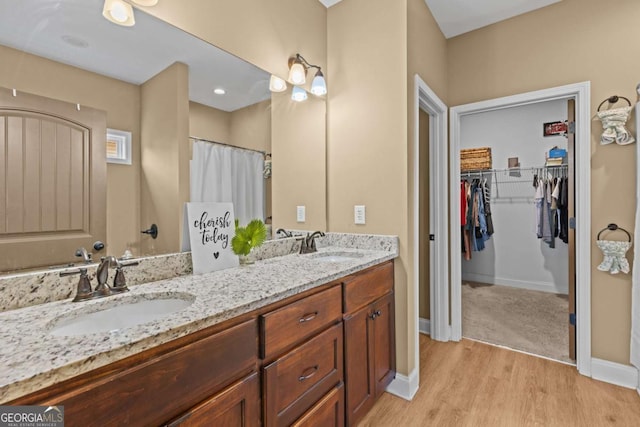 419 Highland Pointe Dr, Alto, GA 30510 - full bath featuring double vanity, wood finished floors, and a walk in closet