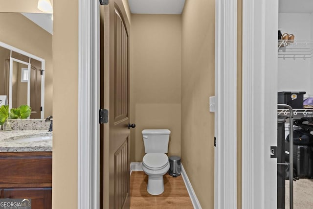 419 Highland Pointe Dr, Alto, GA 30510 - bathroom with vanity, wood finished floors, and a walk in closet