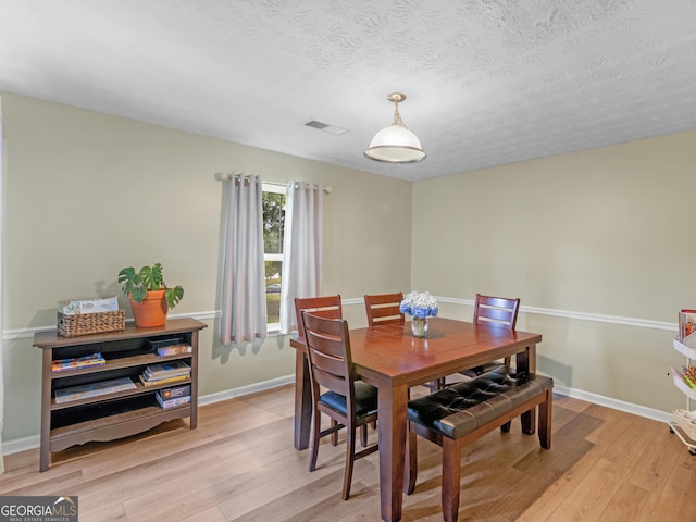 300 Furrow Creek Ct, Jackson, GA 30233 - dining room with light wood finished floors, a textured ceiling, and baseboards