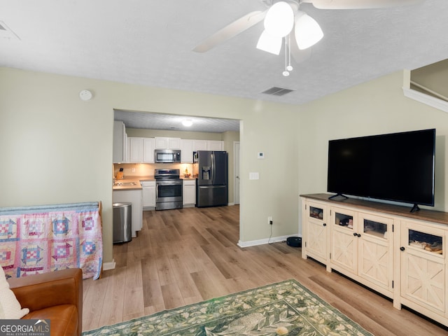 300 Furrow Creek Ct, Jackson, GA 30233 - living room with light wood-style floors, a ceiling fan, and baseboards