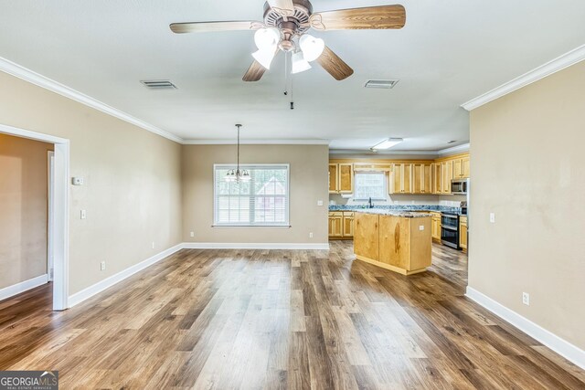 103 Mossy Creek Way, Ochlocknee, GA 31773 - kitchen with light brown cabinets, appliances with stainless steel finishes, ornamental molding, light countertops, and wood finished floors