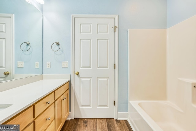 103 Mossy Creek Way, Ochlocknee, GA 31773 - bathroom featuring vanity, wood finished floors, and washtub / shower combination