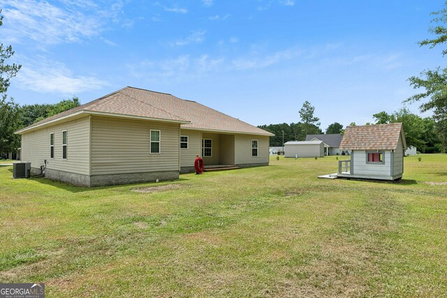 103 Mossy Creek Way, Ochlocknee, GA 31773 - rear view of property with central AC unit, a lawn, and roof with shingles