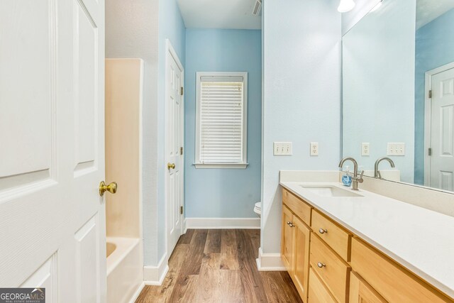 103 Mossy Creek Way, Ochlocknee, GA 31773 - full bath featuring vanity, wood finished floors, baseboards, and toilet