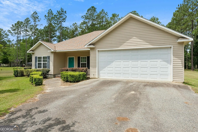 103 Mossy Creek Way, Ochlocknee, GA 31773 - ranch-style house with asphalt driveway, a shingled roof, a front yard, and a garage
