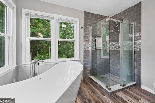 1005 Wellers Ct, Roswell, GA 30076 - full bath featuring a soaking tub, a shower stall, wood finished floors, and toilet