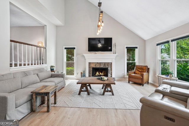 1005 Wellers Ct, Roswell, GA 30076 - living area featuring high vaulted ceiling, light wood finished floors, a fireplace, and baseboards