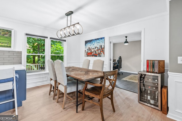 1005 Wellers Ct, Roswell, GA 30076 - dining space with beverage cooler, ornamental molding, light wood finished floors, and a chandelier