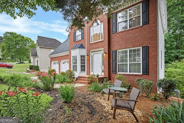 2018 Township Dr, Woodstock, GA 30189 - view of front facade featuring a garage and brick siding