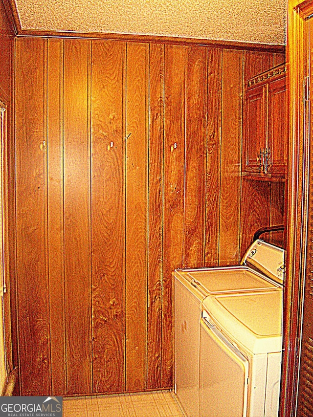 6177 County Road 266, Five Points, AL 36855 - laundry room featuring washer and clothes dryer, cabinet space, and wooden walls