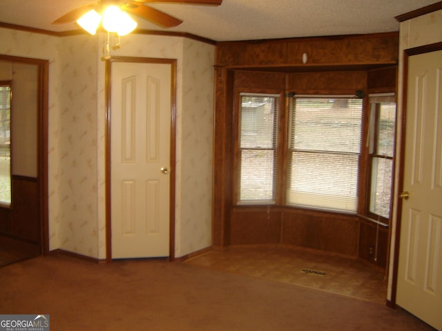 6177 County Road 266, Five Points, AL 36855 - unfurnished dining area featuring ceiling fan, healthy amount of natural light, carpet, ornamental molding, and wallpapered walls
