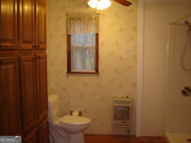 6177 County Road 266, Five Points, AL 36855 - bathroom with heating unit, a shower, toilet, wallpapered walls, and ceiling fan