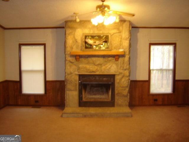 6177 County Road 266, Five Points, AL 36855 - unfurnished living room featuring wainscoting, wooden walls, ceiling fan, crown molding, and carpet flooring