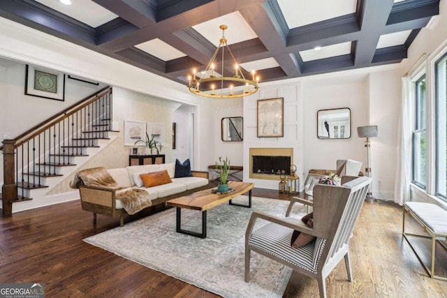 4085 Hillcrest View Ct, Suwanee, GA 30024 - living area featuring stairway, a chandelier, beam ceiling, wood finished floors, and coffered ceiling