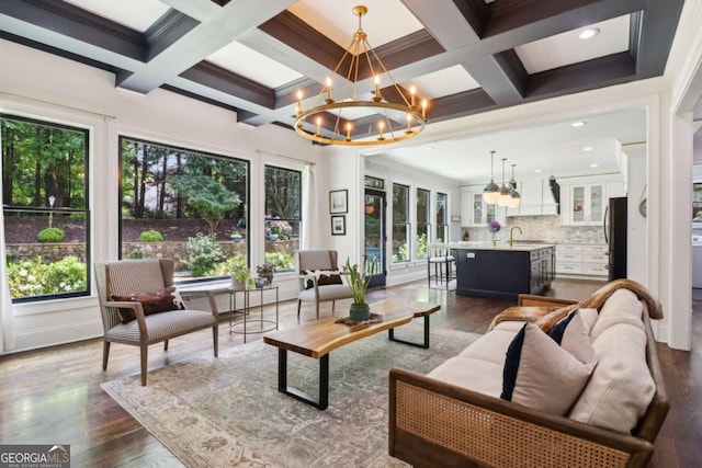 4085 Hillcrest View Ct, Suwanee, GA 30024 - living room featuring plenty of natural light, a chandelier, beamed ceiling, dark wood finished floors, and coffered ceiling