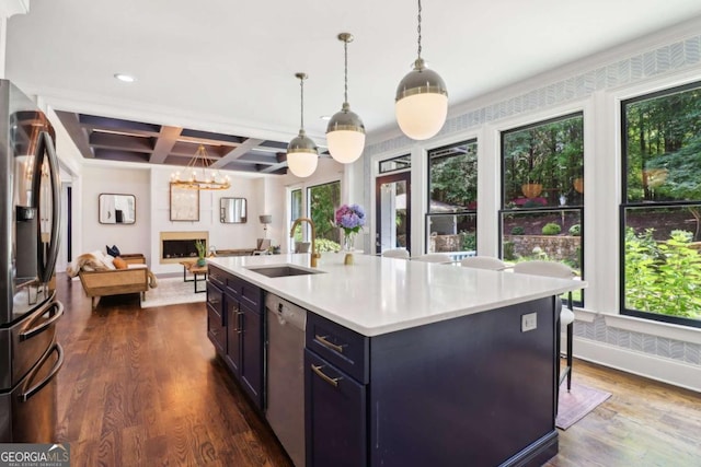 4085 Hillcrest View Ct, Suwanee, GA 30024 - kitchen featuring appliances with stainless steel finishes, a sink, coffered ceiling, healthy amount of natural light, and dark wood-style floors
