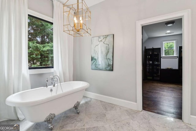 4085 Hillcrest View Ct, Suwanee, GA 30024 - full bathroom with baseboards, a soaking tub, and a chandelier