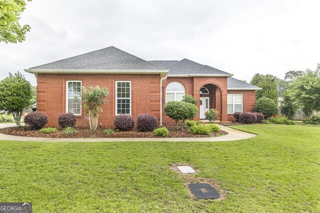 201 Loudon Hill Dr, Warner Robins, GA 31088 - view of front of house with a front yard, roof with shingles, and brick siding