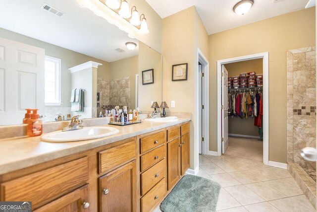 201 Loudon Hill Dr, Warner Robins, GA 31088 - bathroom with double vanity, a walk in shower, tile patterned floors, and a spacious closet