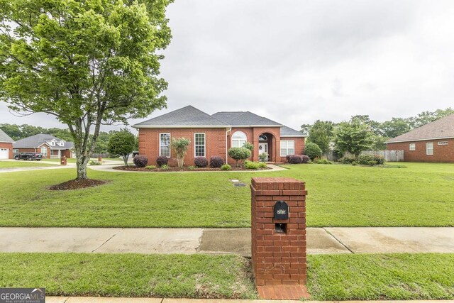 201 Loudon Hill Dr, Warner Robins, GA 31088 - view of front facade featuring a front lawn, brick siding, and a shingled roof