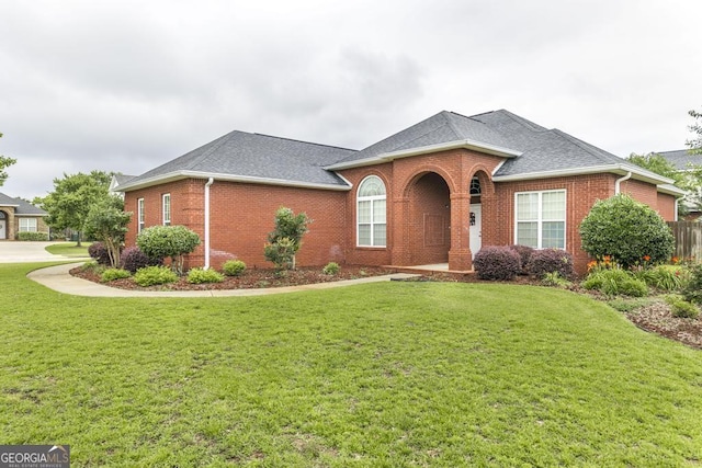 201 Loudon Hill Dr, Warner Robins, GA 31088 - view of front facade featuring brick siding, a front lawn, and roof with shingles