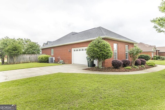 201 Loudon Hill Dr, Warner Robins, GA 31088 - view of side of property with central air condition unit, brick siding, concrete driveway, and an attached garage