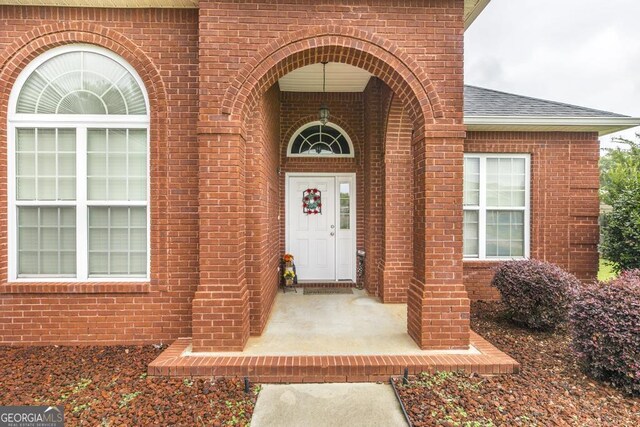 201 Loudon Hill Dr, Warner Robins, GA 31088 - view of exterior entry with brick siding and a shingled roof