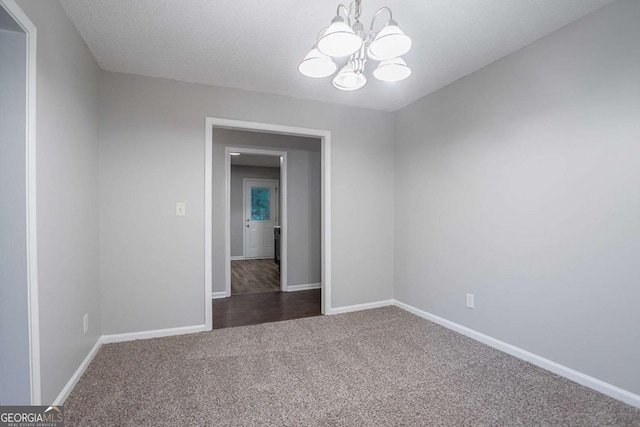 220 Harwell Rd NW, Atlanta, GA 30331 - spare room with a chandelier, dark carpet, and baseboards