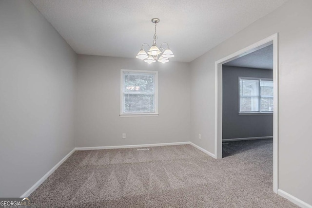 220 Harwell Rd NW, Atlanta, GA 30331 - empty room featuring plenty of natural light, carpet flooring, and a chandelier