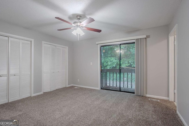 220 Harwell Rd NW, Atlanta, GA 30331 - unfurnished bedroom featuring access to exterior, carpet, multiple closets, a textured ceiling, and baseboards