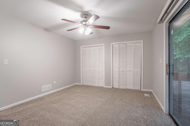 220 Harwell Rd NW, Atlanta, GA 30331 - unfurnished bedroom with two closets, carpet floors, baseboards, and a textured ceiling