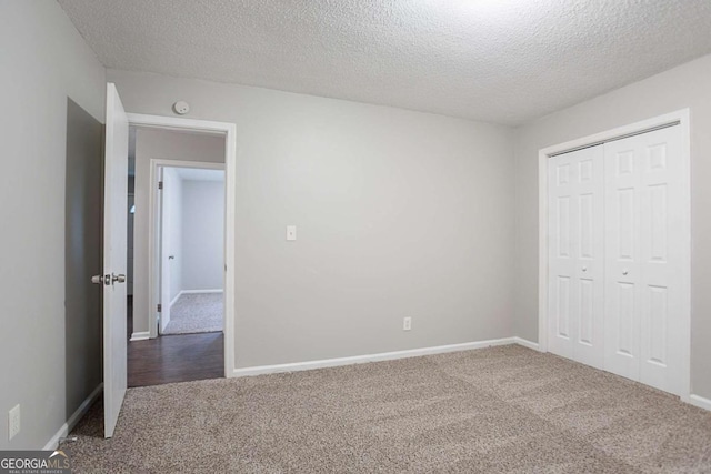 220 Harwell Rd NW, Atlanta, GA 30331 - unfurnished bedroom with carpet, a textured ceiling, a closet, and baseboards