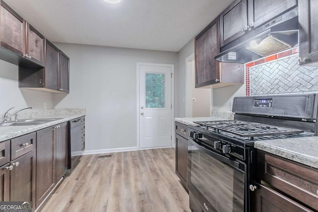 220 Harwell Rd NW, Atlanta, GA 30331 - kitchen featuring black gas stove, under cabinet range hood, a sink, and dark brown cabinetry