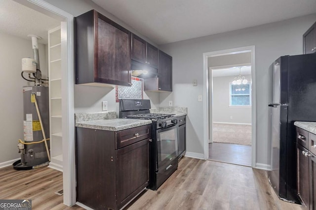 220 Harwell Rd NW, Atlanta, GA 30331 - kitchen with gas stove, freestanding refrigerator, water heater, light wood-style flooring, and light countertops
