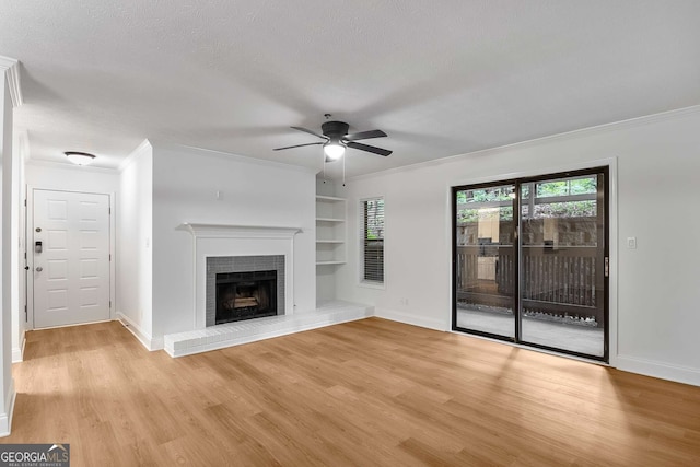 1603 Cumberland Ct, Smyrna, GA 30080 - unfurnished living room featuring light wood-style floors, ceiling fan, baseboards, built in shelves, and ornamental molding