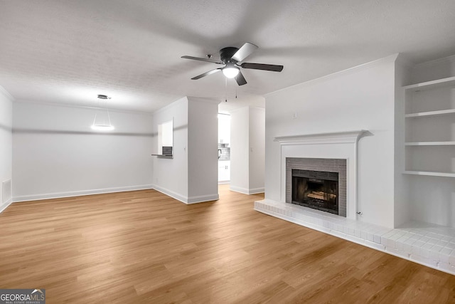 1603 Cumberland Ct, Smyrna, GA 30080 - unfurnished living room with ornamental molding, a ceiling fan, light wood-type flooring, a brick fireplace, and baseboards