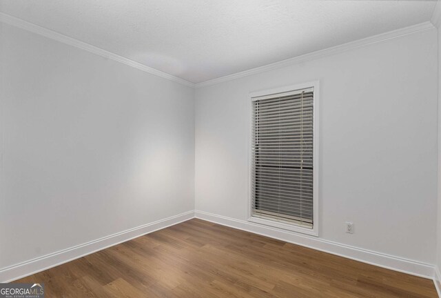 1603 Cumberland Ct, Smyrna, GA 30080 - spare room featuring dark wood-style flooring, baseboards, and ornamental molding