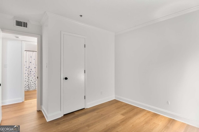 1603 Cumberland Ct, Smyrna, GA 30080 - unfurnished bedroom featuring light wood finished floors, crown molding, baseboards, and a closet