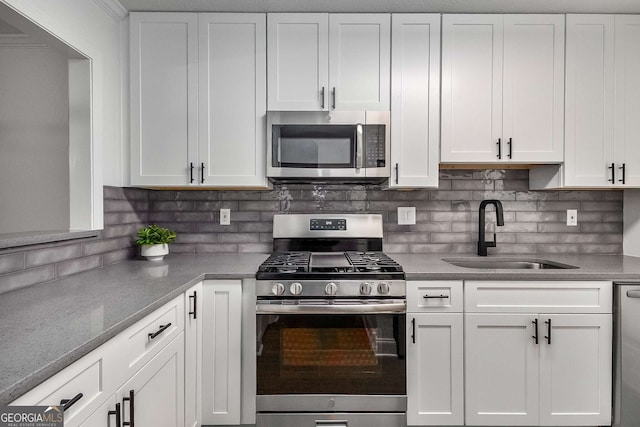 1603 Cumberland Ct, Smyrna, GA 30080 - kitchen with appliances with stainless steel finishes, a sink, white cabinets, and tasteful backsplash