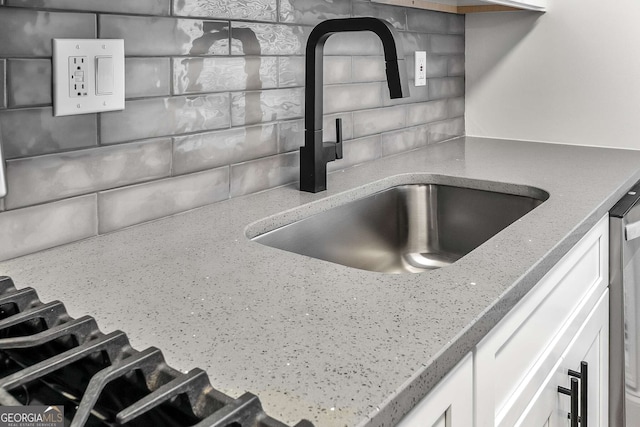 1603 Cumberland Ct, Smyrna, GA 30080 - kitchen view of a sink, tasteful backsplash, and light stone countertops