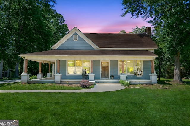 1382 6th Ave, Auburn, GA 30011 - view of front of home with covered porch, a lawn, a chimney, and roof with shingles