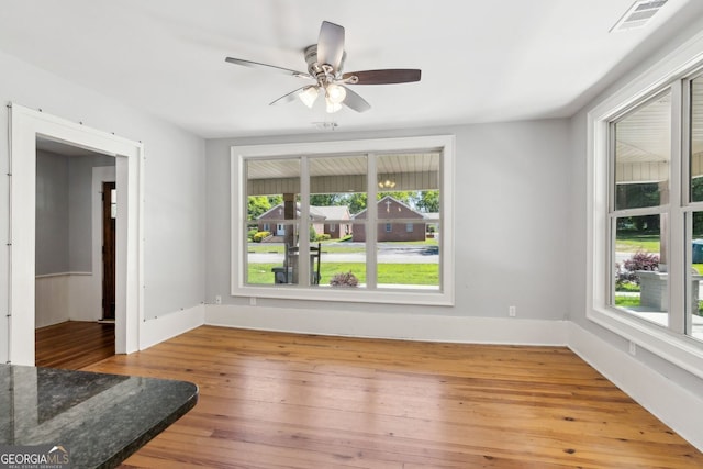 1382 6th Ave, Auburn, GA 30011 - empty room with healthy amount of natural light, wood-type flooring, and ceiling fan