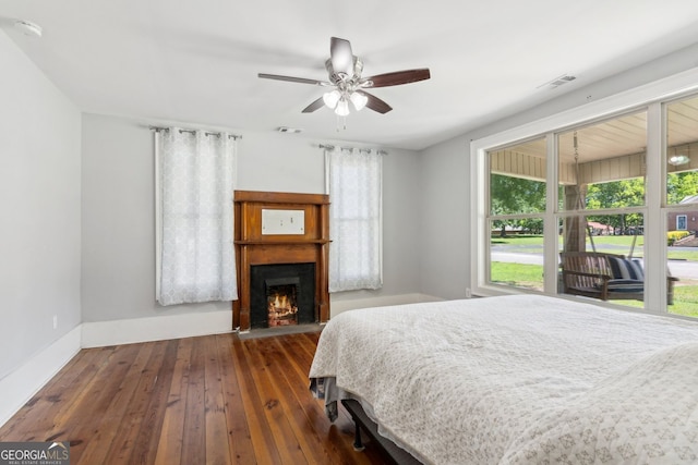 1382 6th Ave, Auburn, GA 30011 - bedroom featuring hardwood / wood-style flooring, a lit fireplace, and a ceiling fan